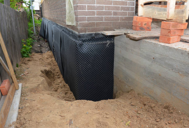 SJ Waterproofing Pros technician performing targeted Waterproofing assessment in Watertown, WI